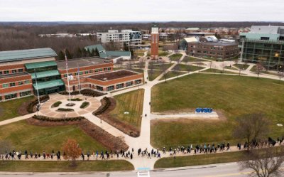 drone photo of crowd participating in silent march during MLK week, they are marching in front of the student services building
