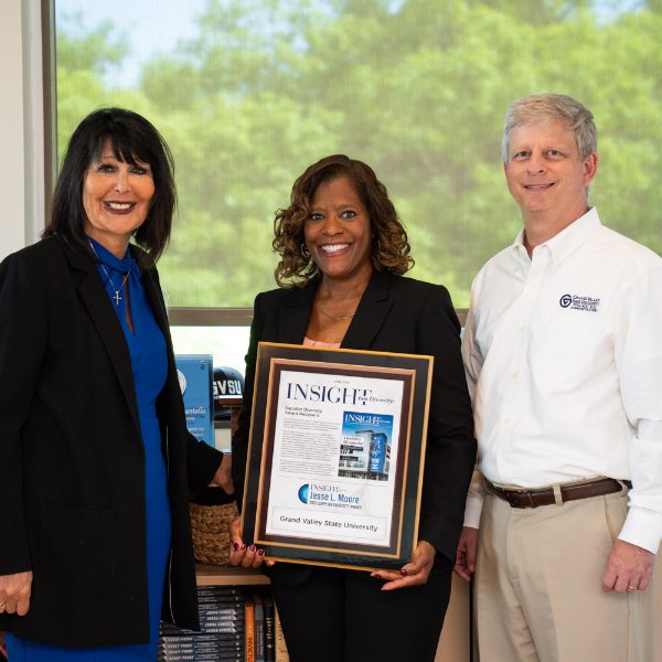 from left are President Mantella, Valerie Rhodes-Sorrelle and Greg Sanial. Valerie is holding a large plaque from Insight into Diversity.