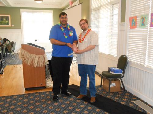 At right, Joel Wendland, assistant professor of liberal studies, accepts the outstanding faculty award from Gabe Pena, graduate assistant for the Oliver Wilson Freshman Academy Program.