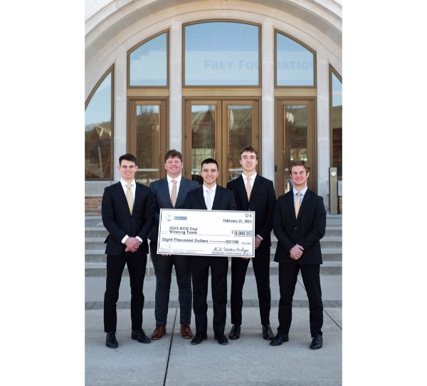 Members of the Seidman IPO student organization pose with a large check after winning the ACG Cup.