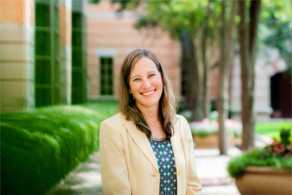 Erica Hamilton in tan blazer standing outside