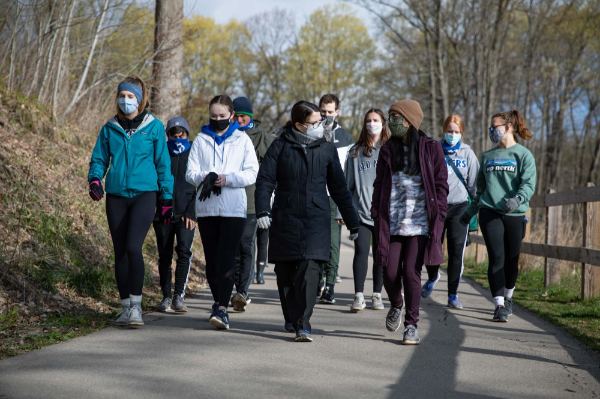 Provost Maria Cimitile walks with students to the boat launch area at the Grand Ravines North County Park.