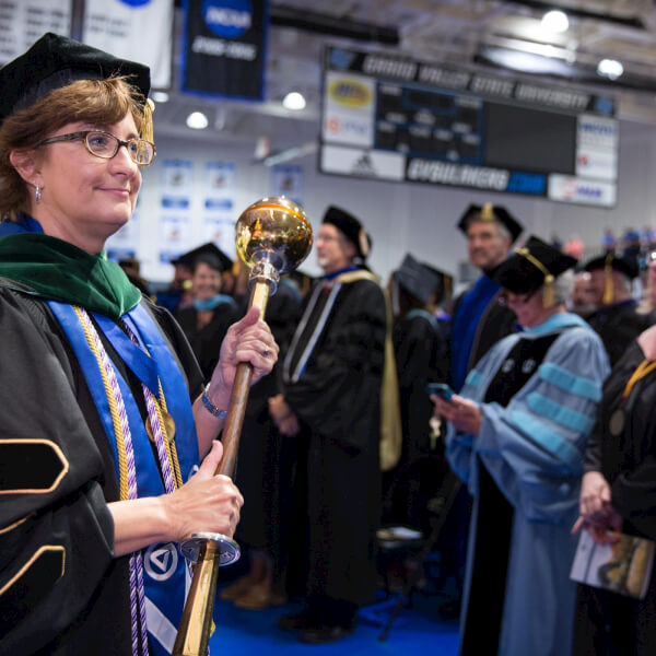 Nursing faculty member Joy Washburn is the mace bearer during convocation at the Fieldhouse August 26.