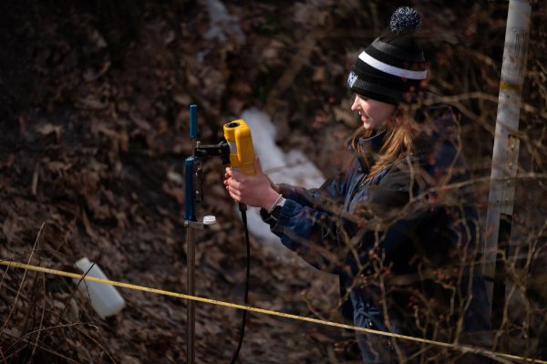 Graduate student Ellen Foley takes measurements in Grand Rapids as part of her research.