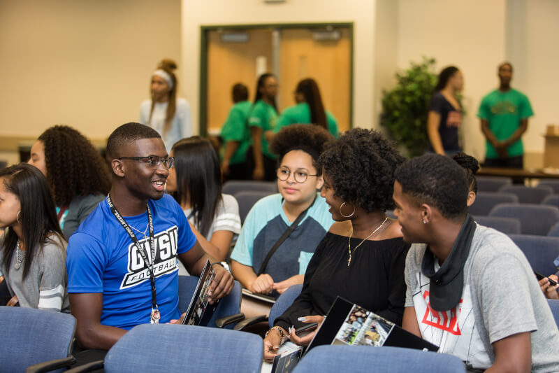students talking while sitting in room
