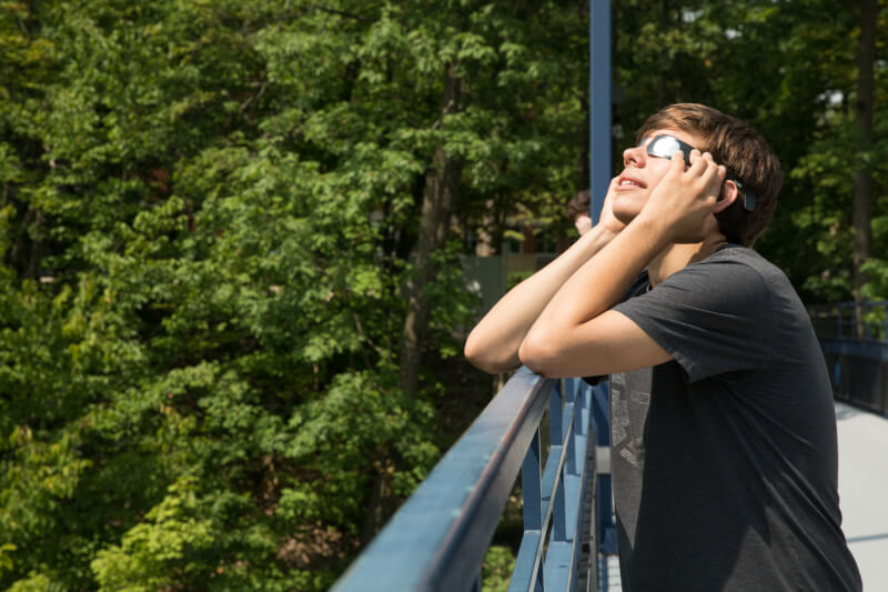 Student watching solar eclipse