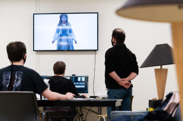 Production team members check the technology for the show.