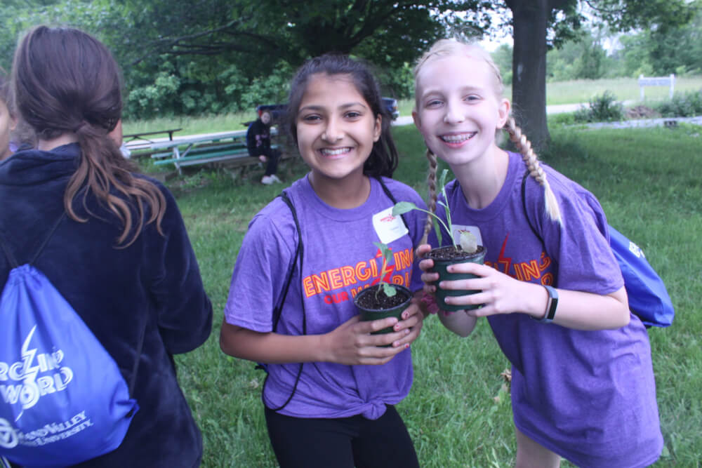 Campers holding kale they will plant at the Sustainable Agriculture Project.