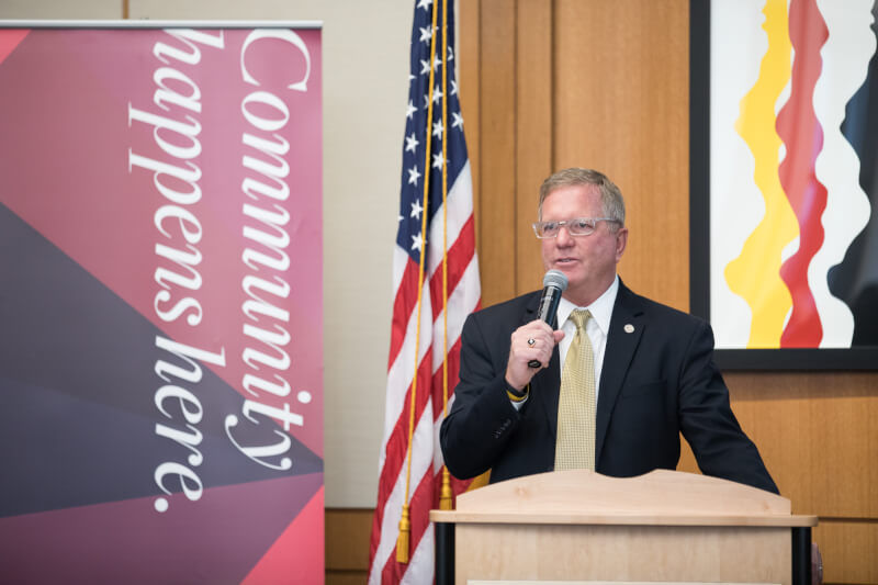 Man speaking in front of podium to audience