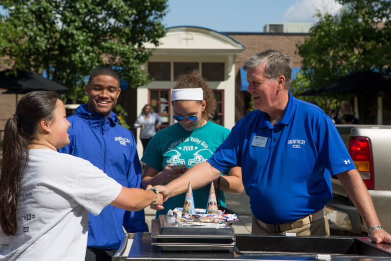  President Thomas J. Haas greets new students. 