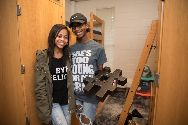  Mother and daughter setting up dorm room