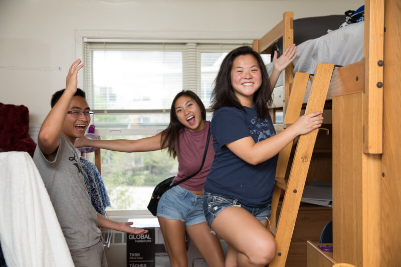  Three GVSU student laughing in dorm room