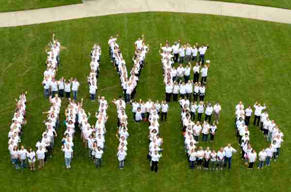 United Way volunteers line up to spell out 'Live United' on lawn.