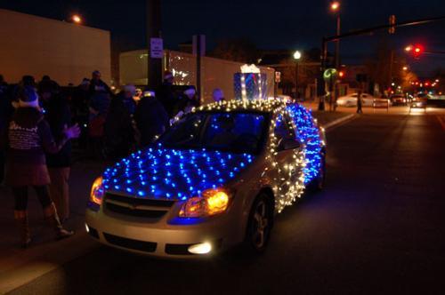 The parade entry included a car decorated with blue and white lights.