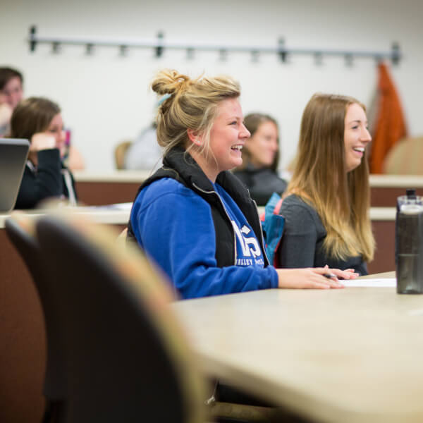 A photo of students smiling in class.