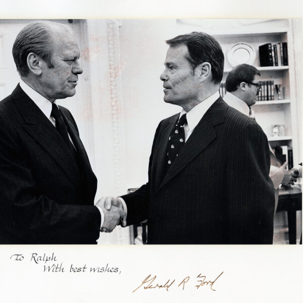 Ralph Hauenstein, right, shakes hands with President Gerald Ford, left.
