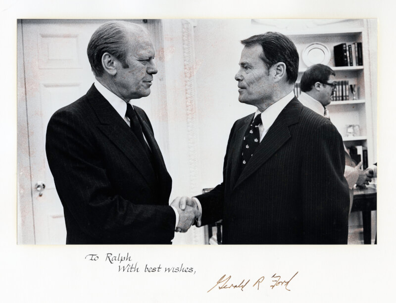Ralph Hauenstein, right, shakes hands with President Gerald Ford, left.
