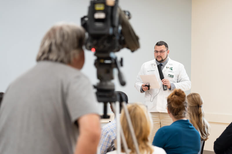 man with microphone, TV camera videotaping