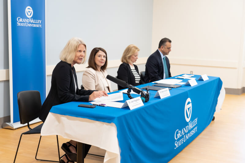 woman talking behind table of four people