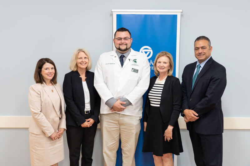 five people standing