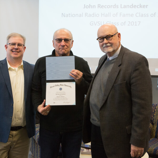 John Records Landecker (middle) pictured with Len O'Kelly (left), and dean Fred Antczak (right) after receiving his diploma February 8.
