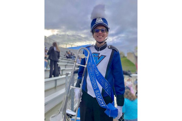 trombone player in Laker Marching Band uniform with homecoming regent sash over her shoulder