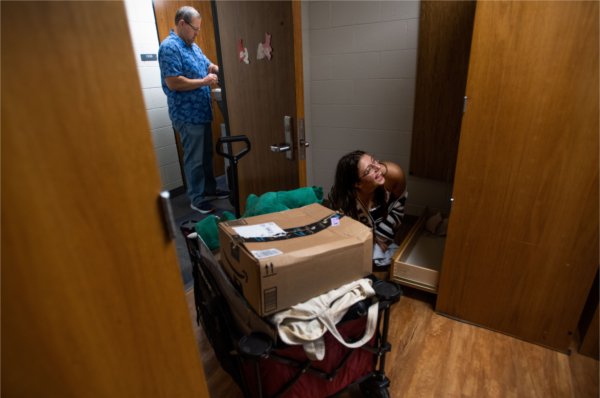 A student moves her belongings into her room in one of Grand Valley's living centers. 