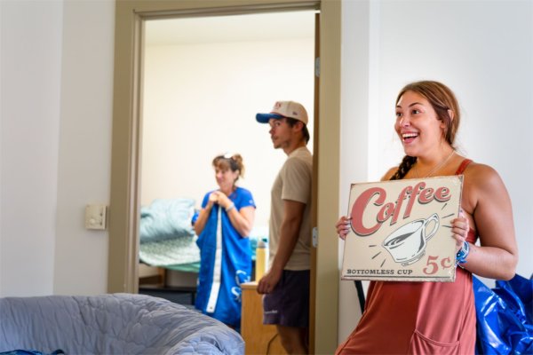 A student shows off a sign she purchased for her and her best friend's room. 