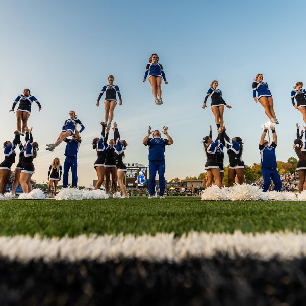 Cheerleaders are hoisted into the air at Lubbers Stadium.