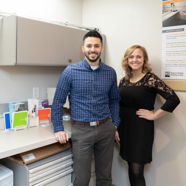 man, woman standing in nurse station