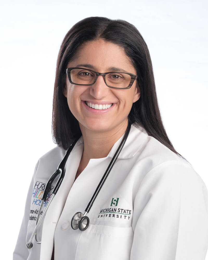 headshot: Dr. Mona Hanna-Attisha in lab coat