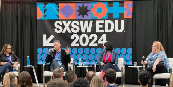 President Mantella sits on stage between other panelists. A colorful banner behind her reads SXSW EDU 2024.