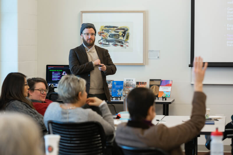 man standing in front of room giving presentation