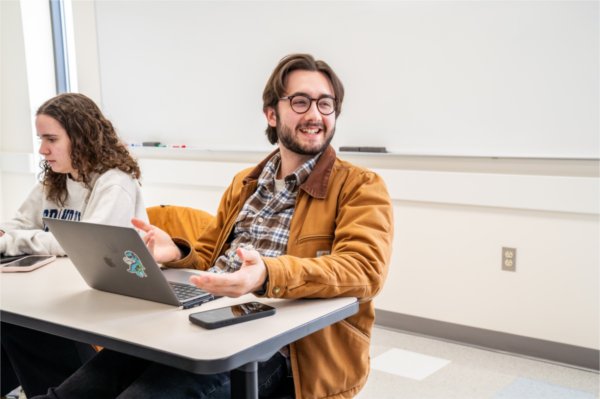 Student Jackson Hicks shares a laugh with a classmate during their English/Women, Gender and Sexuality 461 class.