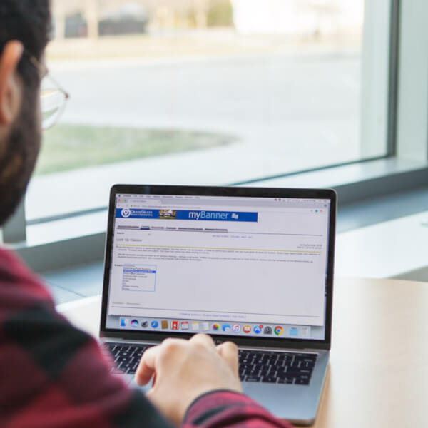 a photo of a student looking at his mybanner. 