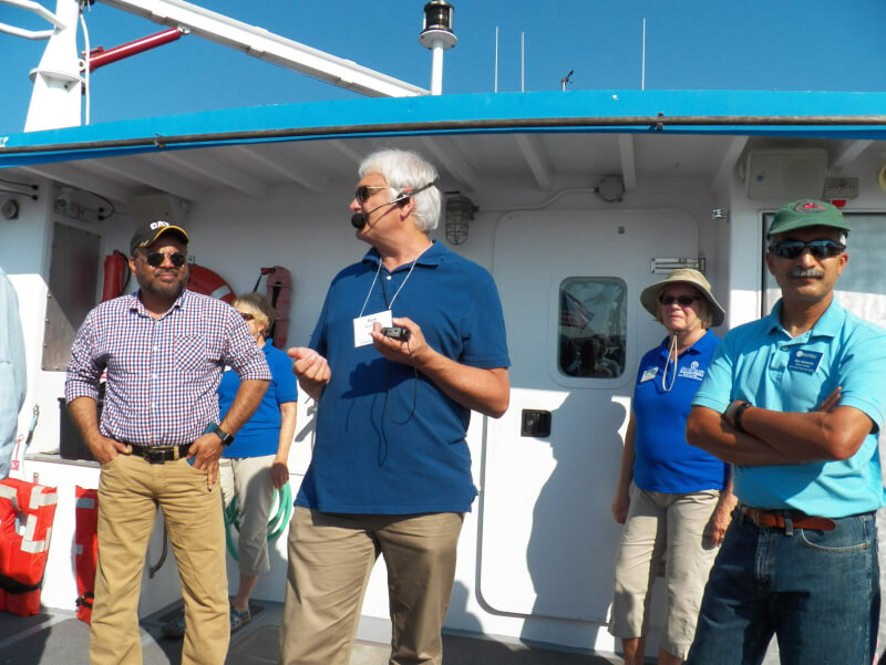 Rick Rediske, middle, and Bopi Biddanda, right, teach water treatment workers aboard the W.G. Jackson research vessel.