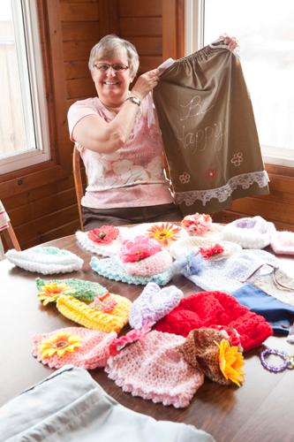 Sally Vissers holds a dress she made from a pillowcase. Participants at a MLK session will make similar crafts.