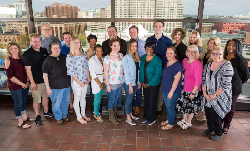 two rows of people standing in front of windows