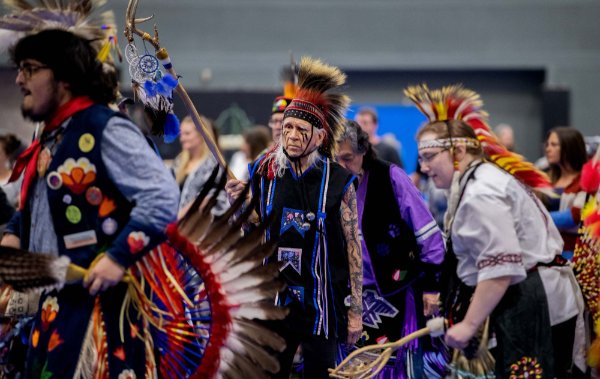 Vyana Slattery, center, dances during the Pow wow. Slattery's Native American name is Dragonfly Wind Walker.
