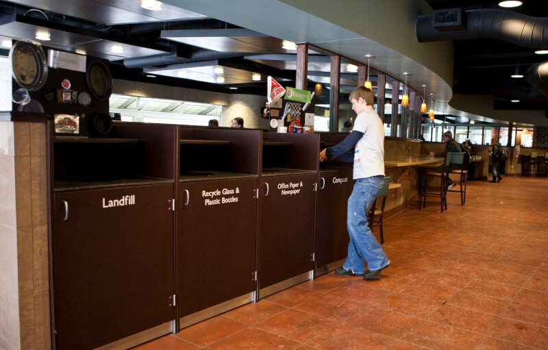 A photo of a student throwing away trash.