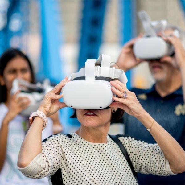 Guests try on virtual reality headsets at a GVSU event during Tech Week.