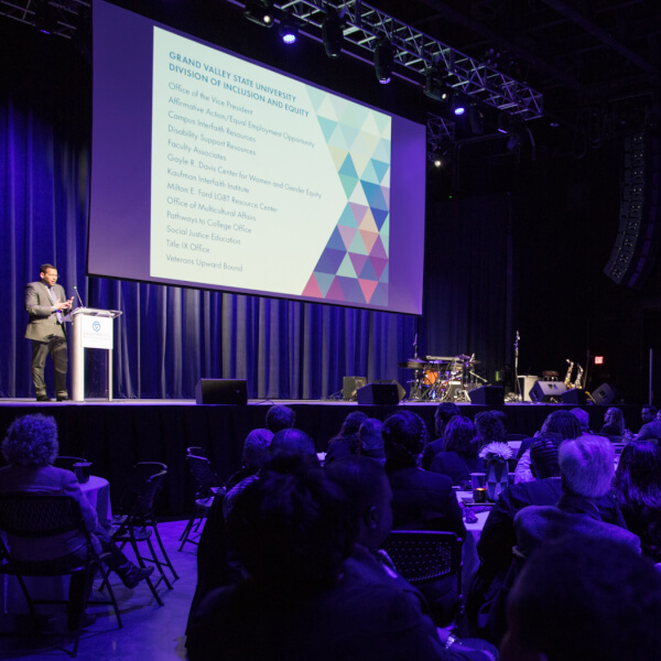man on stage in front of audience