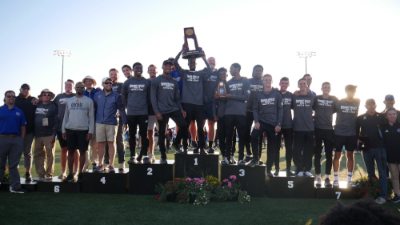 members of the Laker men's track and field team stand with the first-place NCAA national championship trophy