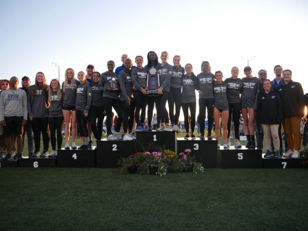members of the Laker Women's Track and Field team stand with the runner-up trophy at the NCAA Division II outdoor championships.