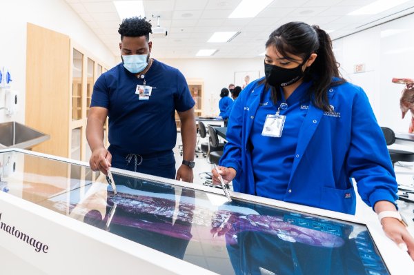Nursing students using virtual anatomy table.