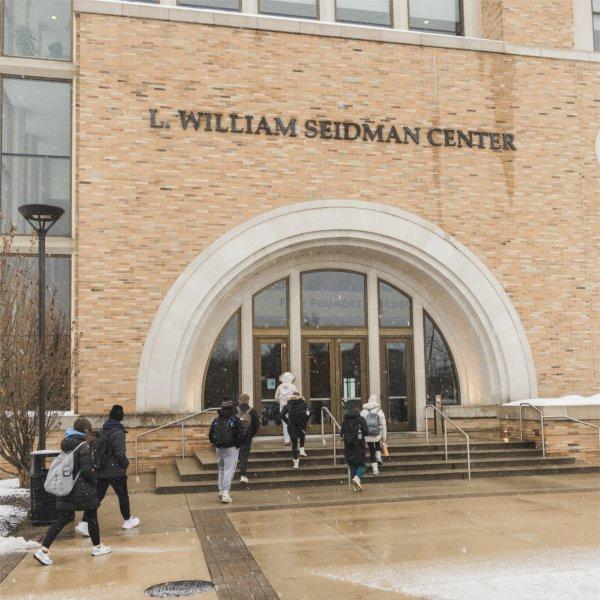 Exterior of L. William Seidman Center as students enter the building