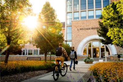 Students walk toward entrance of the L. WIlliam Seidman Center
