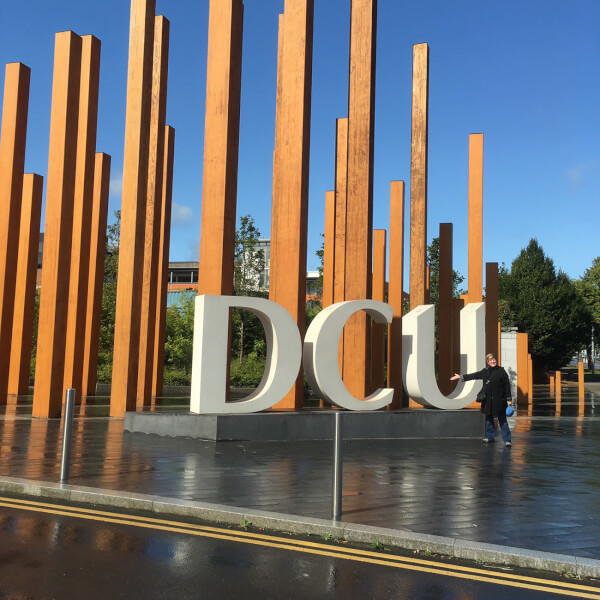 woman in front of signage at Dublin City University
