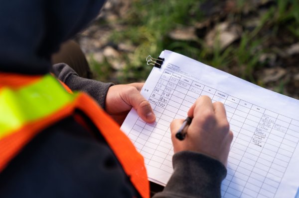 A researcher records information from a water sample on a paper chart.