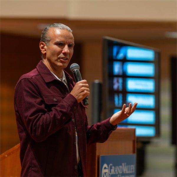 Anton Treuer speaks on stage, holding a microphone.